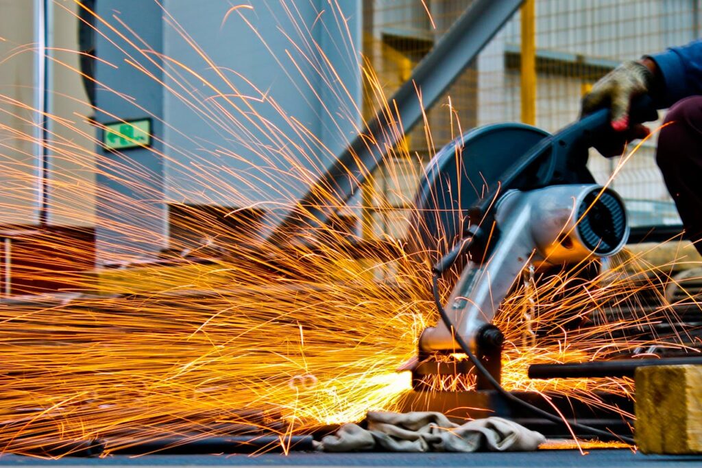 Mastering the First Impression: Your intriguing post title goes here A worker operates a grinder cutting metal, creating a vibrant display of sparks in an industrial setting.
